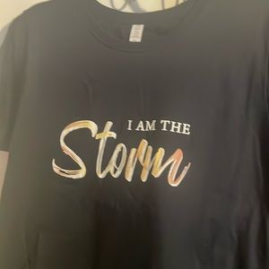 A 2X runs small so I would say 1X “I am the storm” t-shirt.
